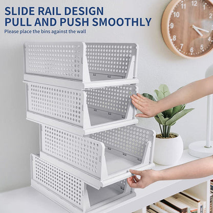 Clothes organizer with four plastic drawers, foldable and stackable for efficient storage.