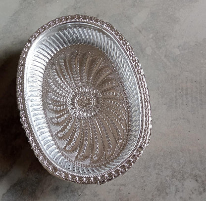 Multipurpose oval silver tray with a royal pattern for various uses.